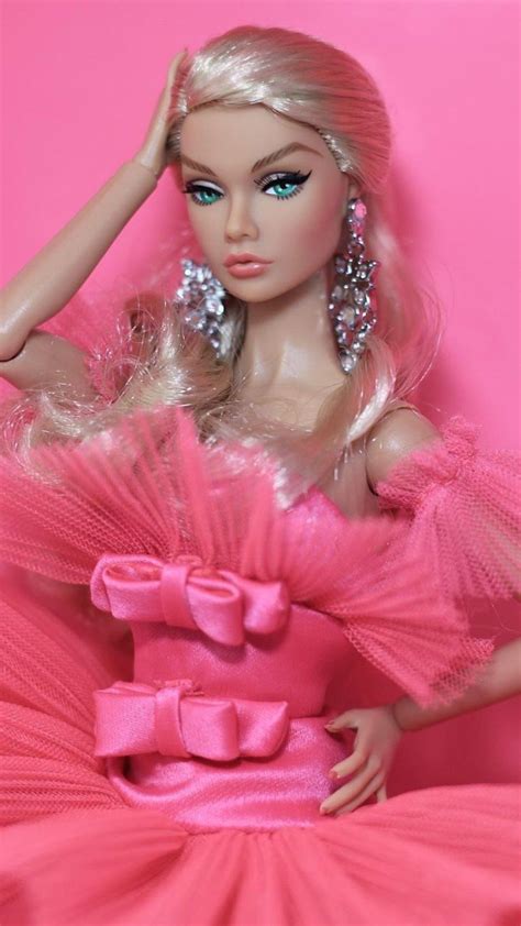 A Barbie Doll Wearing A Pink Dress And Earrings