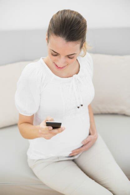 Premium Photo Casual Pregnant Woman Using Her Smartphone Touching Her