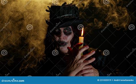 Sinister Old Mature Woman In Carnival Costume Of Halloween Witch Making