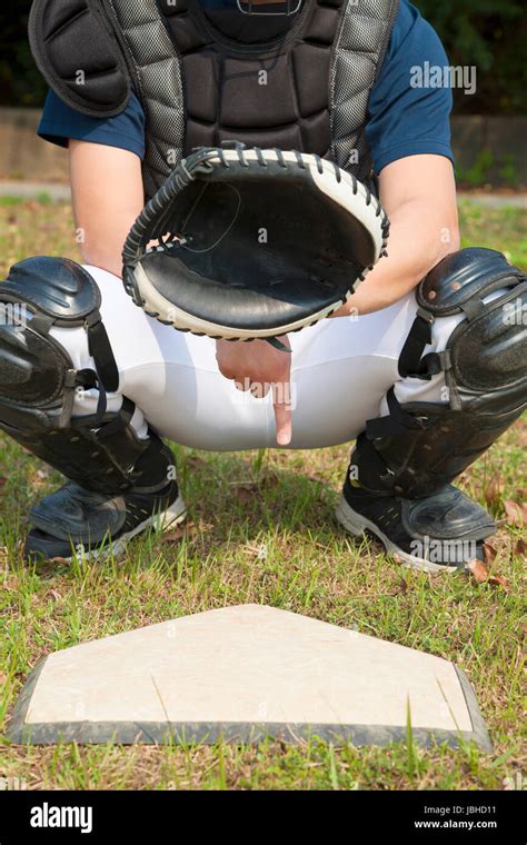 baseball catcher showing secret signal gesture Stock Photo - Alamy