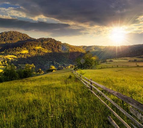 Fence On Hillside Meadow In Mountain At Sunset Stock Image Image Of