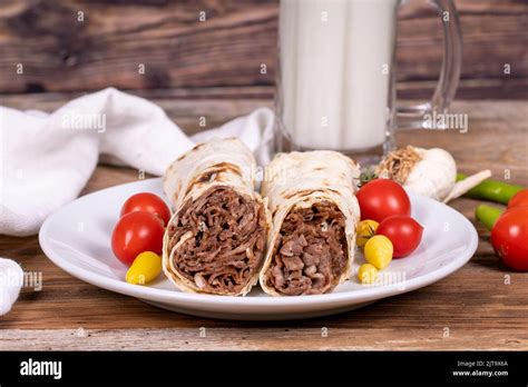 Wrap Doner Kebab. Meat doner kebab on wooden background. Traditional Turkish cuisine. Close-up ...