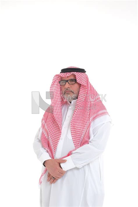 side view of a close-up of a Saudi man in traditional Saudi dress ...