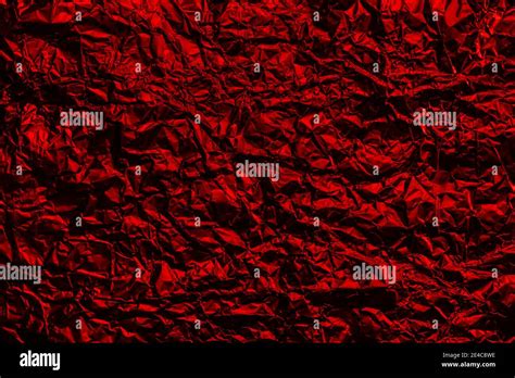 Red Foil Background With Shiny Crumpled Surface For Texture Background