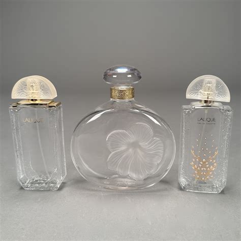 Lot 046 Three Lalique Perfume Bottles 2 6″h 1 6 12″h Largest Is Nina Ricci Eau De Fleurs