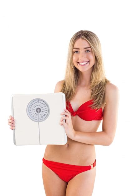 Premium Photo Fit Blonde In Red Bikini Showing Scales