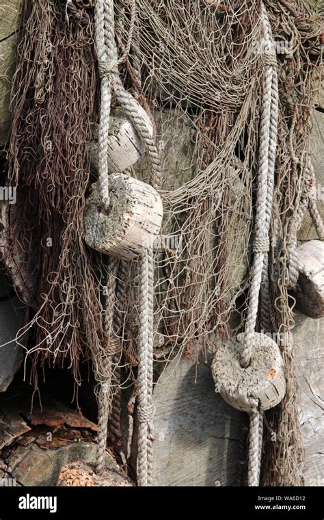 old fishing nets with cork floats attached Stock Photo - Alamy