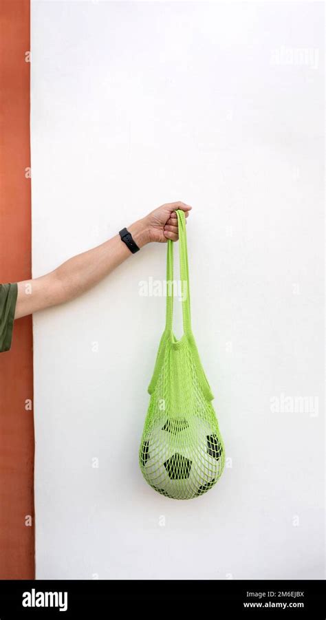 Soccer ball in eco mesh shopping bag Stock Photo - Alamy