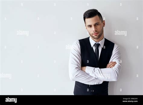 Handsome Confident Man In Elegant Suit With Crossed Arms On White