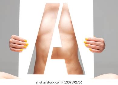 Nude Female Body Behind Stencil Letter Stock Photo