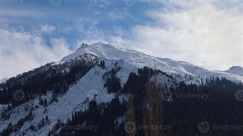 Snowy Mountain Peaks with Alpine Forests, Clouds, Kalam, North Pakistan