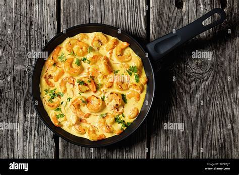 Sauteed Shrimp In Creamy Saffron Sauce In A Frying Pan On A Grey Rustic Wooden Table Spanish