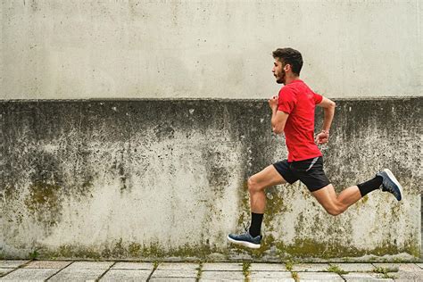 Young Man Running Fast In The Park Photograph By Cavan Images