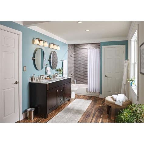 a bathroom with blue walls and wood floors