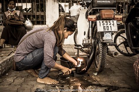 A Girl S Job A Girl Repairing An Old Tyre On A Moto Jeff Perigois