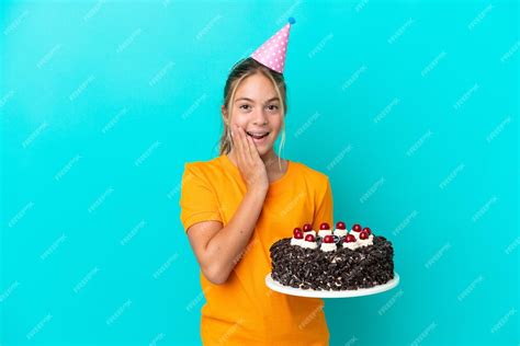 Premium Photo Little Caucasian Girl Holding Birthday Cake Isolated On Blue Background With