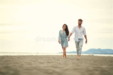 Young Couple In Love Strolling The Beach Stock Image Image Of