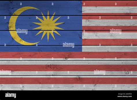 Malaysia Flag Depicted In Bright Paint Colors On Old Wooden Wall Close