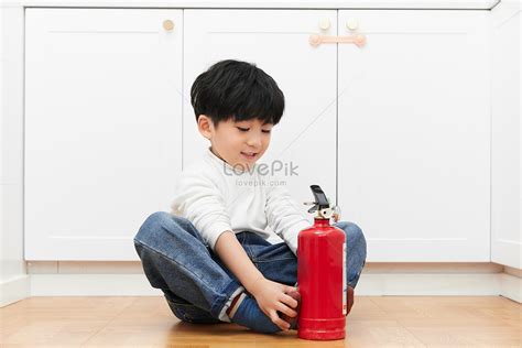 Child Operating Fire Extinguisher In Kitchen Picture And HD Photos ...