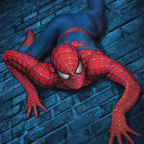 The Amazing Spider Man Is Laying On His Back In Front Of A Brick Wall