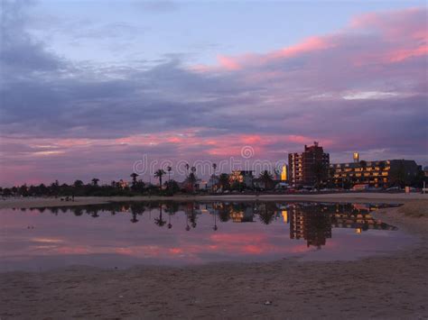 Buildings And Sunset Reflected In Water Stock Image Image Of Palm