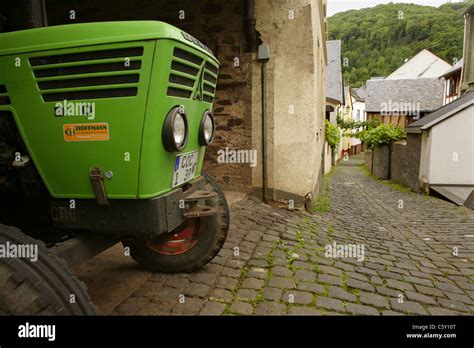 Green Deutz Tractor Used In Vineyards Parked In Narrow Cobbled Street