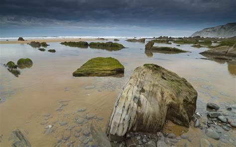 Large Rocks Near Body Of Water Under Gray Sky Hd Wallpaper Wallpaper