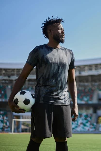 Premium Photo Intense Portrait Of A Football Player Holding The Ball