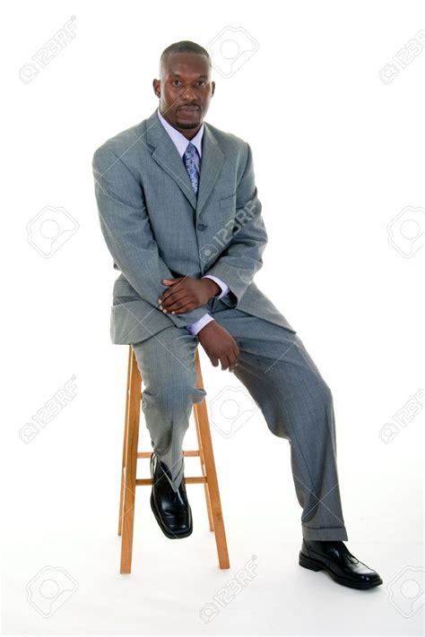 Handsome African American Man In A Gray Business Suit Sitting On A