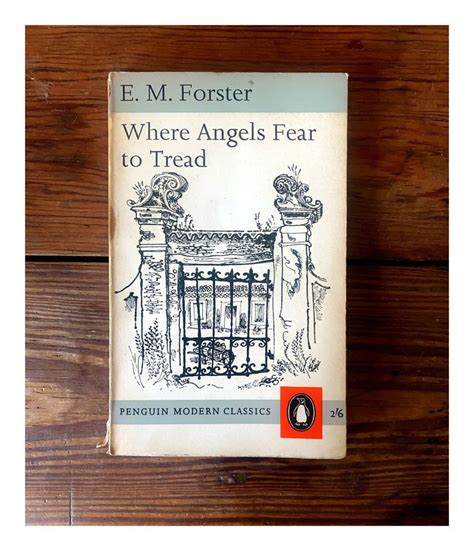 A Person Holding Up A Book About Where Angels Fear To Tread In Front Of