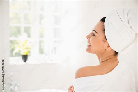 Back View Photo Of Caucasian Middle Aged Mature Woman In Turban And Spa Bathrobe Relaxing After