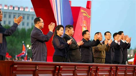 Kim Jong Un His Daughter And Officials Clapping Together At The Grand Opening Of New Housing