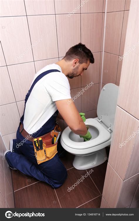 Plumber repairing toilet ⬇ Stock Photo, Image by © belchonock #134816714