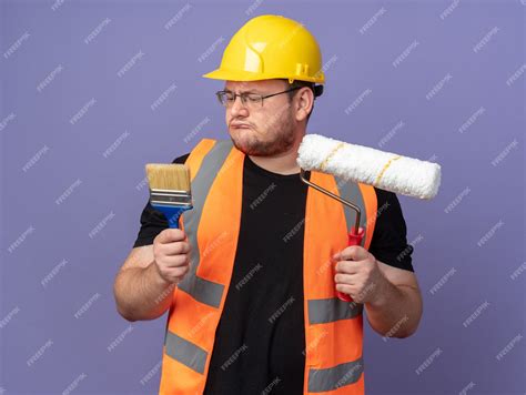 Free Photo | Builder man in construction vest and safety helmet holding