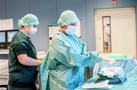 Surgical Staff Preparing For Surgery Photograph By Arno Massee Science