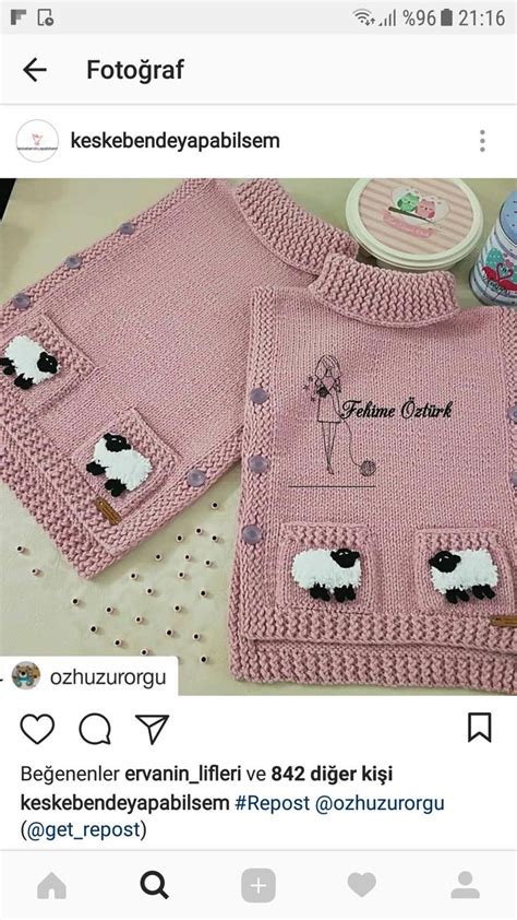 A Knitted Sweater With Sheeps On The Front And Back Is Displayed In An