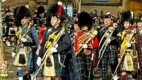 The Massed Pipes And Drums March Out While Plying Scotland The Brave