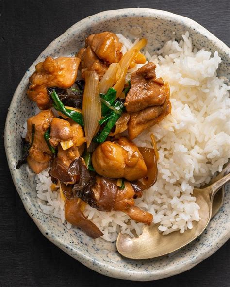 A Bowl Filled With Rice And Meat On Top Of A Table