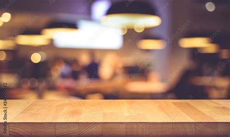 Wood Texture Table Top Counter Bar With Blur Light Gold Bokeh In Cafe