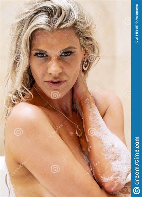 Gorgeous Blonde Model Baths Nude In A Home Environment Stock Image