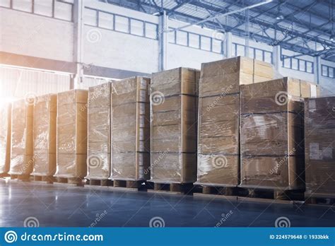 Stacked Of Package Boxes Wrapped Plastic Flim On Pallets At Storage