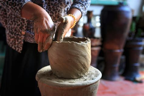 person molding clay pot  stock photo
