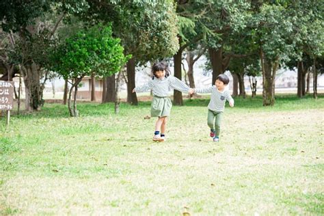 Asian Children Walking Hand In Hand In A Park Full Of Nature Stock ...