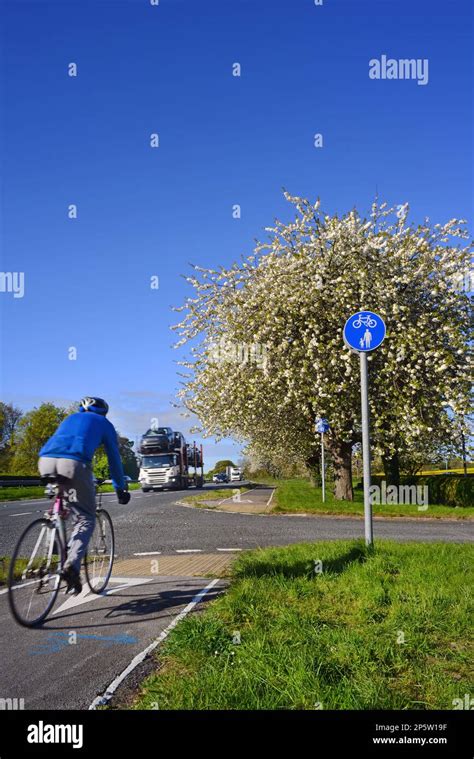 Cyclist Using Designated Cycle Lane At The Side Of The A64 Dual