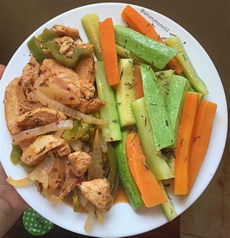 A White Plate Topped With Meat And Veggies