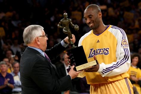 Kobe Bryant with all his trophies | HoopsHype