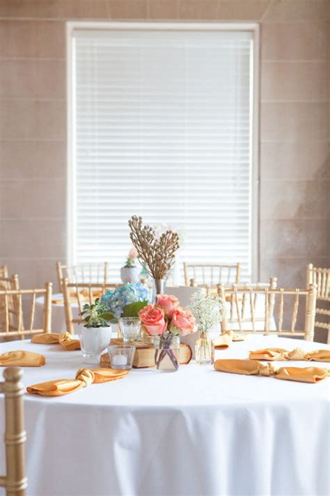 The Table Is Set With Flowers And Gold Place Settings For An Elegant