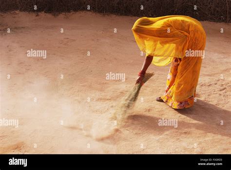 Indian Woman In Ghunghat Sweeping Floor With Broom Jodhpur Rajasthan