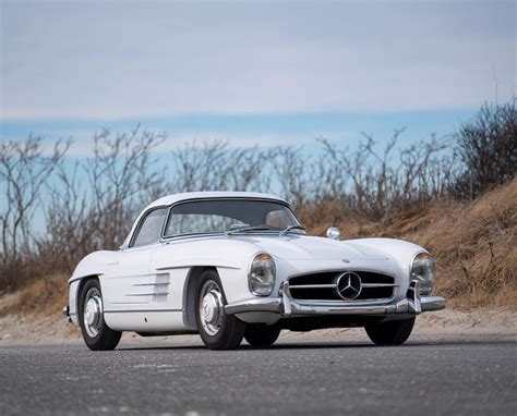 An Old Mercedes Sports Car Is Parked On The Side Of The Road