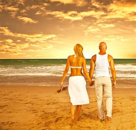 Download Couple At Beach Under Orange Sky Picture